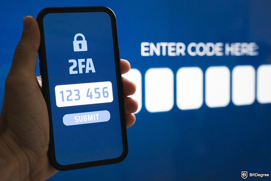 Crypto wallet security: a man holding a smartphone that shows a 2FA passcode.