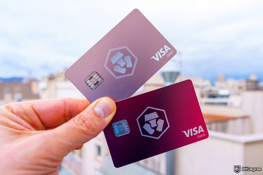 Crypto.com Level Up review: close-up of a hand holding two Crypto.com cards.