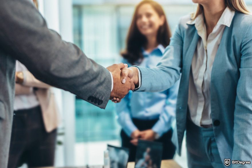 Cryptocurrency jobs: two people handshaking.