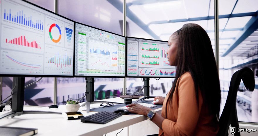 Cryptocurrency jobs: an analyst working on visualized data.