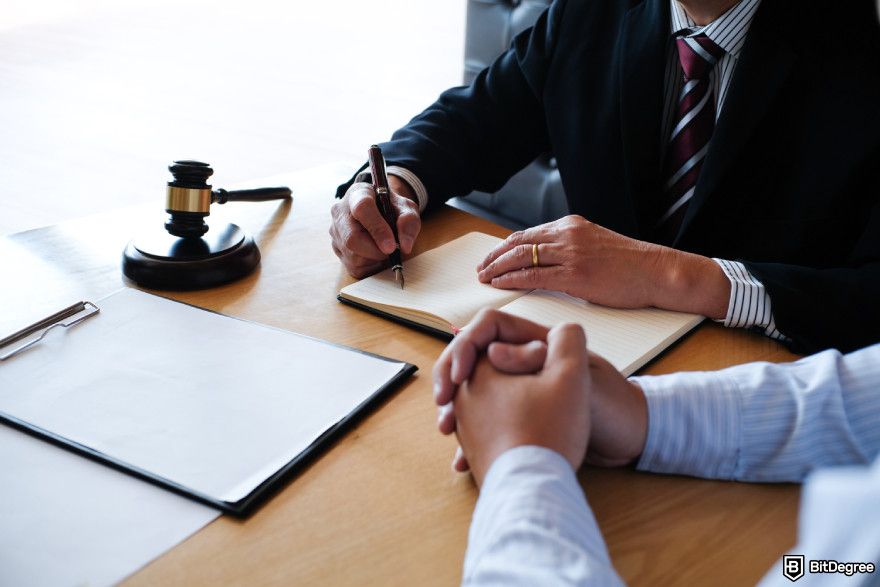 Cryptocurrency jobs: a legal counsel and his client working together.