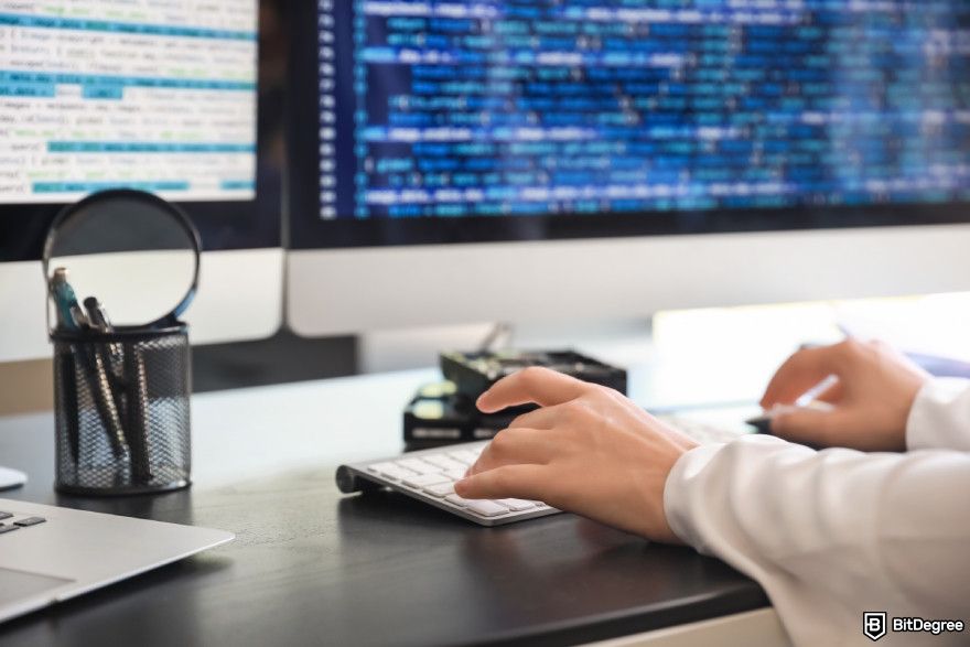 Cryptocurrency jobs: developers' hands typing code on a keyboard.