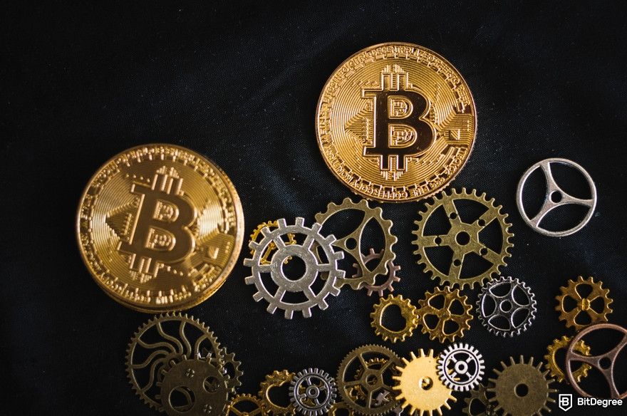 Cryptocurrency security: scattered Bitcoin physical coins and clockworks.