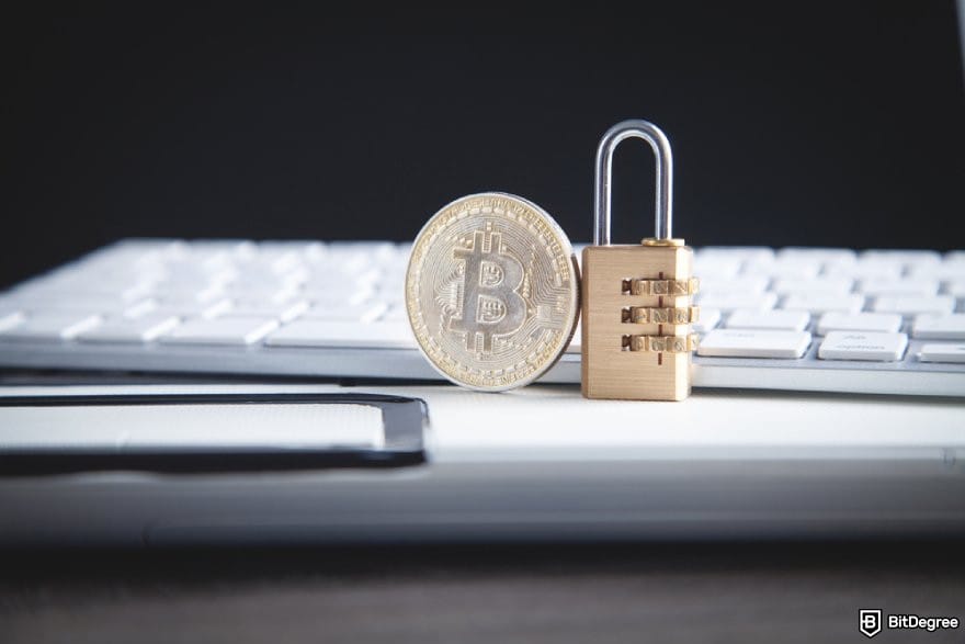 CryptoWatch review: a BTC coin and a padlock beside a computer keyboard.