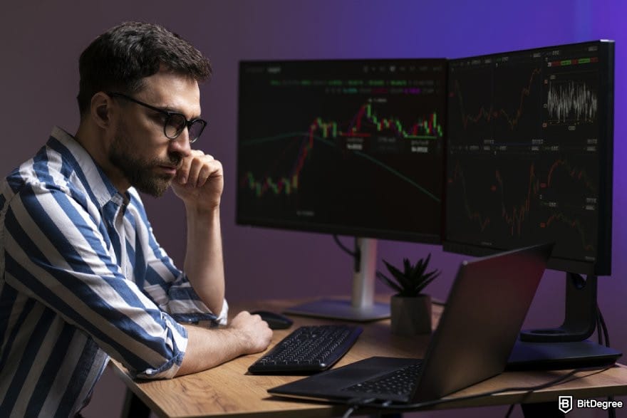 CryptoWatch review: a person analyzing multiple price charts in different monitors.
