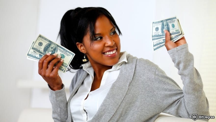 Currency devaluation in Nigeria: a young woman holding plenty of dollars.