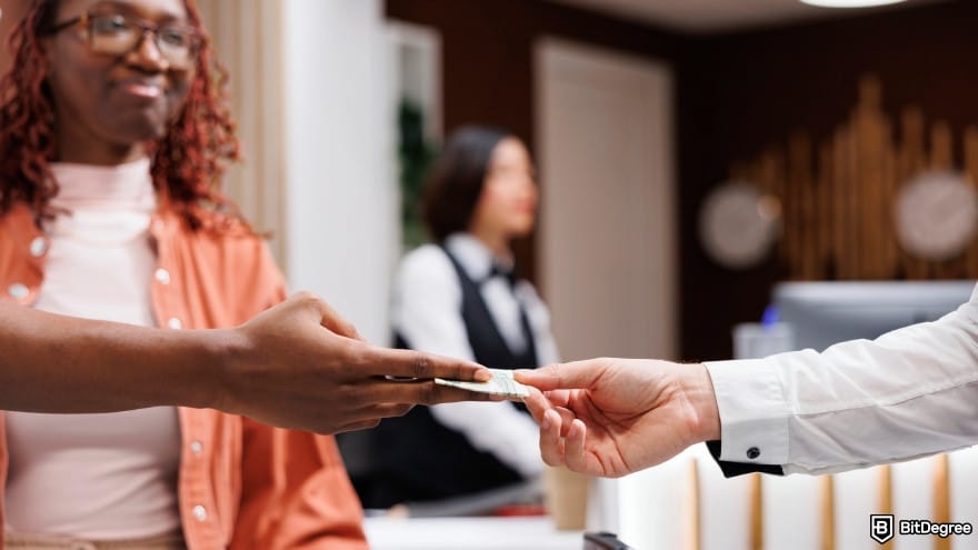 Currency devaluation in Nigeria: a person giving money to steward at front desk counter.