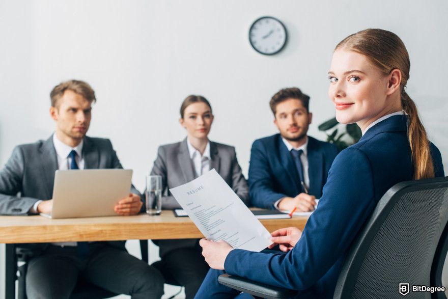 Data analyst courses: a woman smiling while being interviewed.
