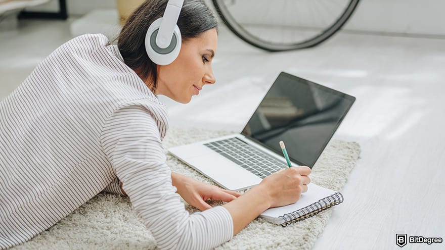 Datacamp vs Coursera: woman taking notes.