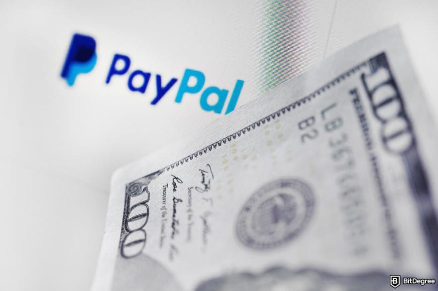 Does PayPal work in Nigeria: a close up of USD 100 bill and a PayPal logo.