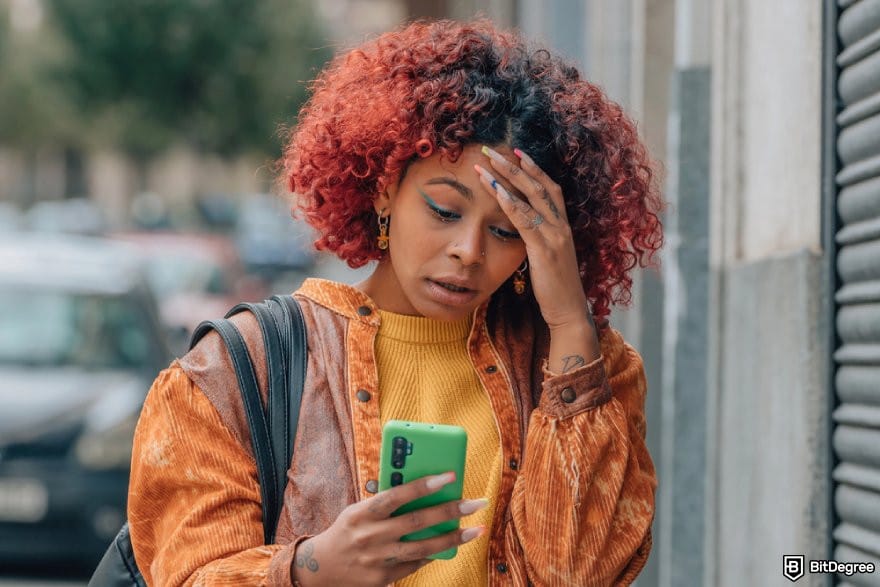 Does PayPal work in Nigeria: a person holding a phone looking frustrated.