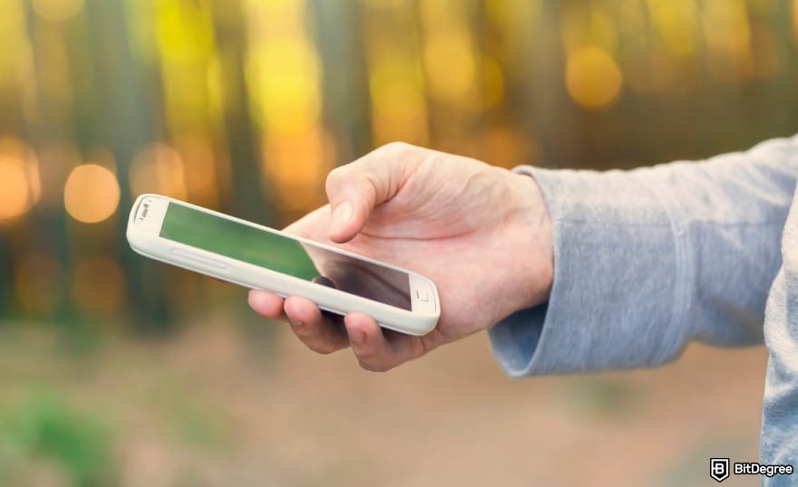 Does Wise work in Turkey: man holding smartphone to illustrate using Wise app.