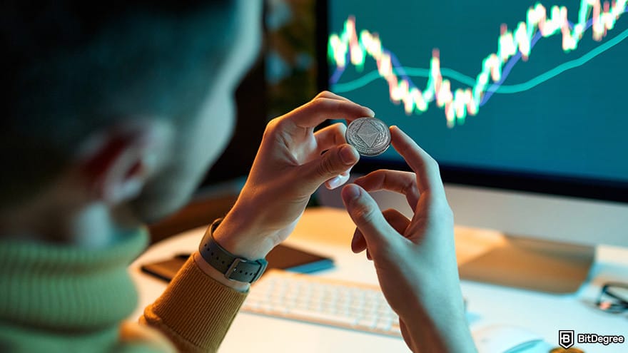 Ethereum cloud mining: A man holding a Ethereum in front of a computer.