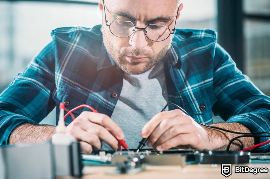 Ethereum staking: a male engineer testing circuit board.