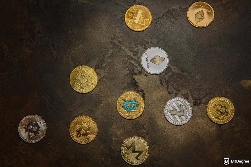 eToro review: different crypto coins on a dark surface.