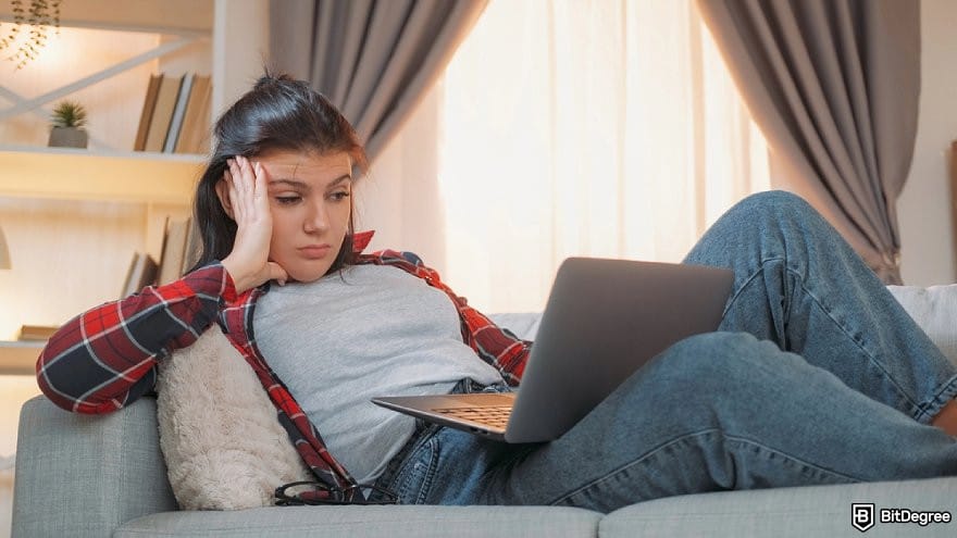eToro review: a person looking at a laptop frustrated.