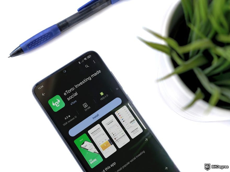 eToro review: a phone displaying the Play Store page of eToro app.