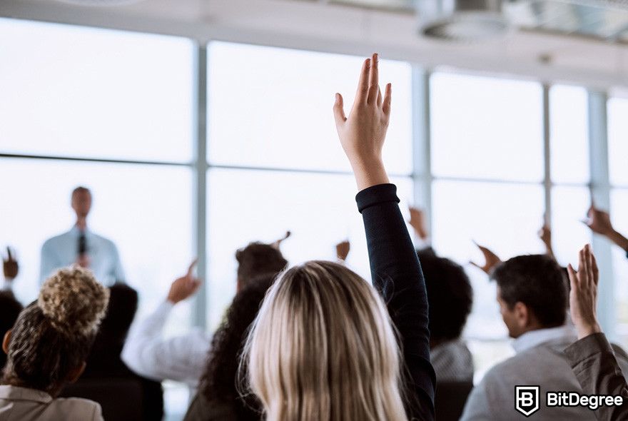 Fractional NFTs: audience members raising hands during a presentation.