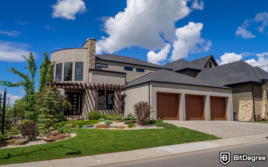 Fractional NFTs: a modern house with curved facade, stone accents, and three-car garage.