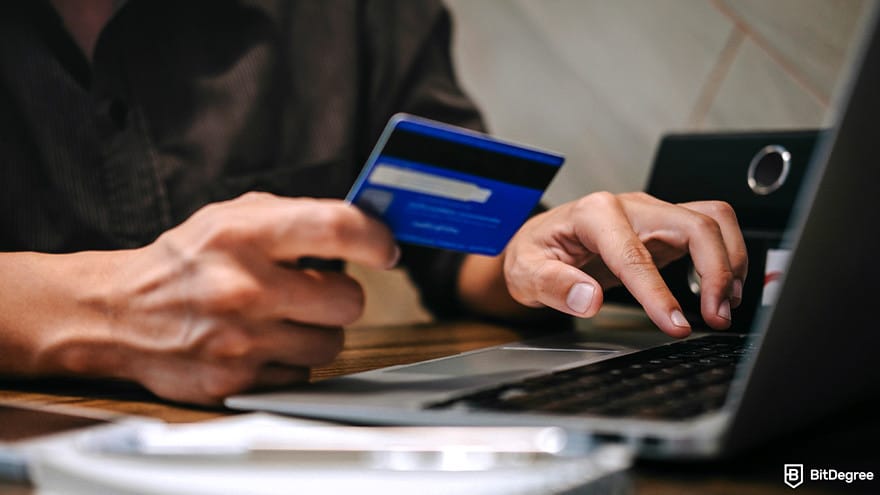 Best Alison courses: person using credit card to buy a certificate.