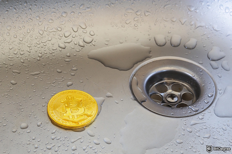 Free crypto rewards: a wet BTC coin on a sink.