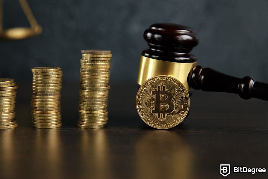 Future of blockchain: a Bitcoin token in front of a gavel with three stacks of coin besides it.