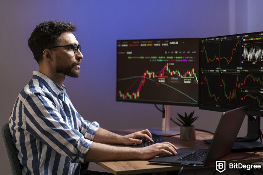 Future of cryptocurrency: A person looking at multiple crypto chart on two screens.