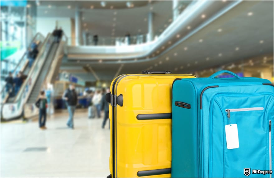 Gemini Credit Card Review: two suitcases in an airport.
