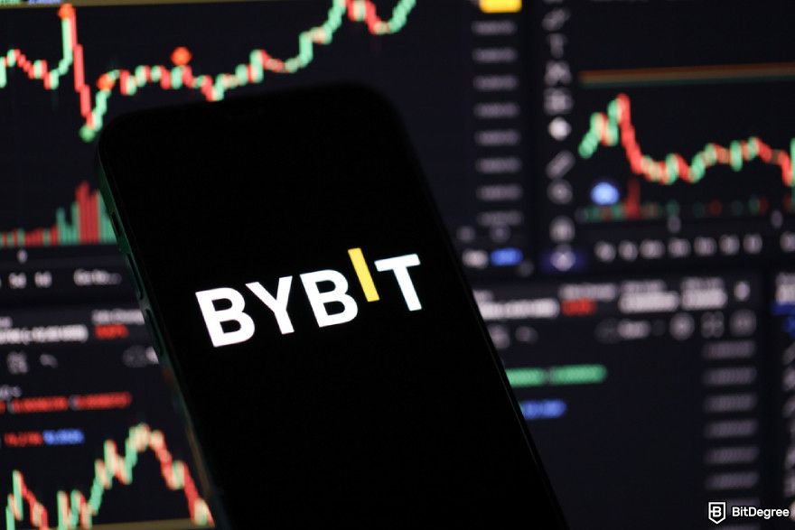 Guide to use AI in crypto arbitrage: Bybit logo on a phone screen.