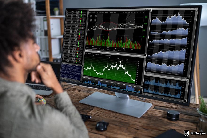 Guide to use AI in crypto arbitrage: young businessman working with graphs at desk.