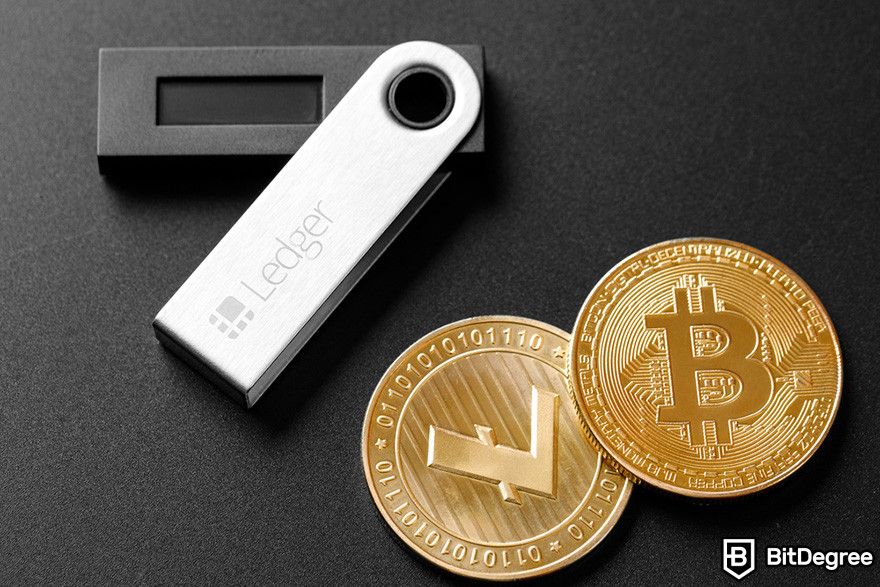 Hard token vs soft token: Ledger's hardware wallet and tokens for Litecoin and Bitcoin on a black surface.