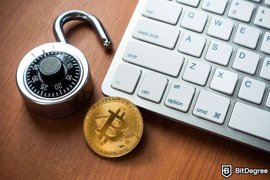 Hardware token: a Bitcoin token in between a padlock and a laptop keyboard.