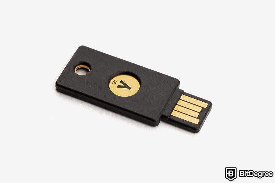 Hardware token: a YubiKey security key on a white background.