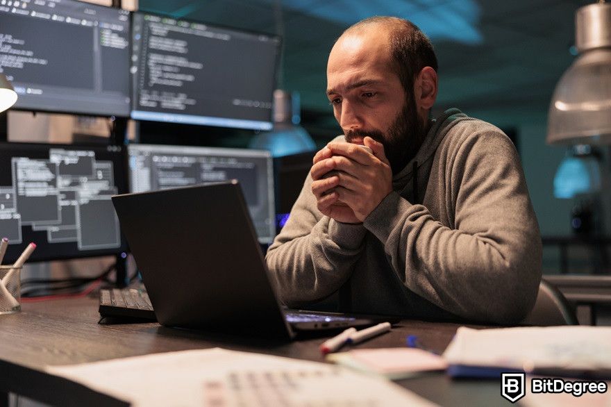 History of cryptocurrency: A man stares at a laptop looking worried.