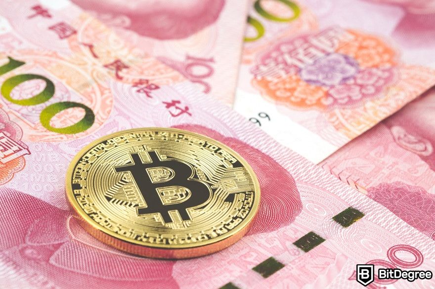 History of cryptocurrency: Golden bitcoin on pile of one hundred Chinese yuan banknotes.