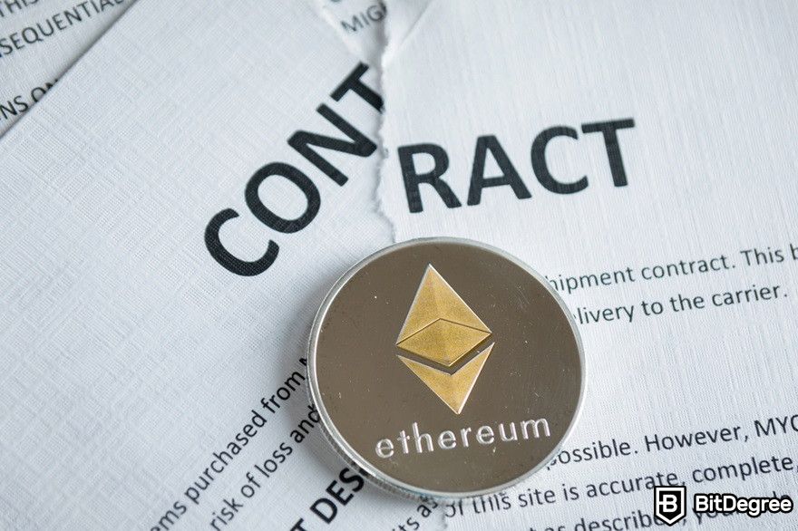 History of cryptocurrency: A torn-up contract with an Ethereum coin.