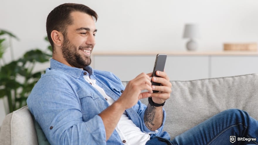 How to add money to Revolut: a person looking at a smartphone.