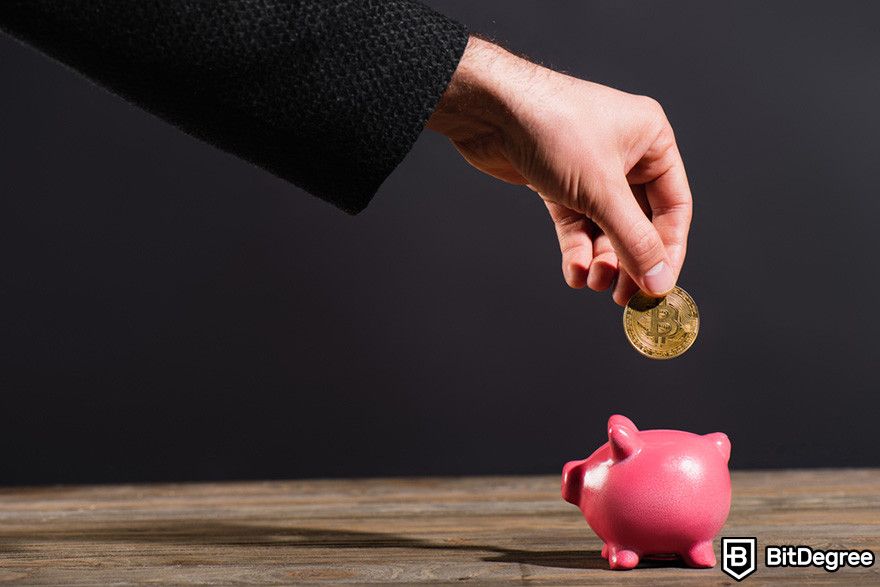 How to borrow against Bitcoin: a person inserting a BTC coin into a piggy bank.