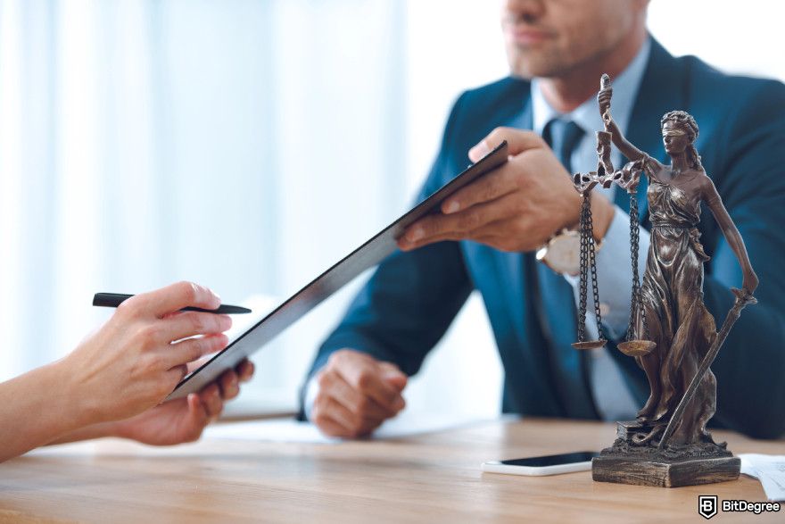 How to build a crypto exchange: a person signing an agreement.