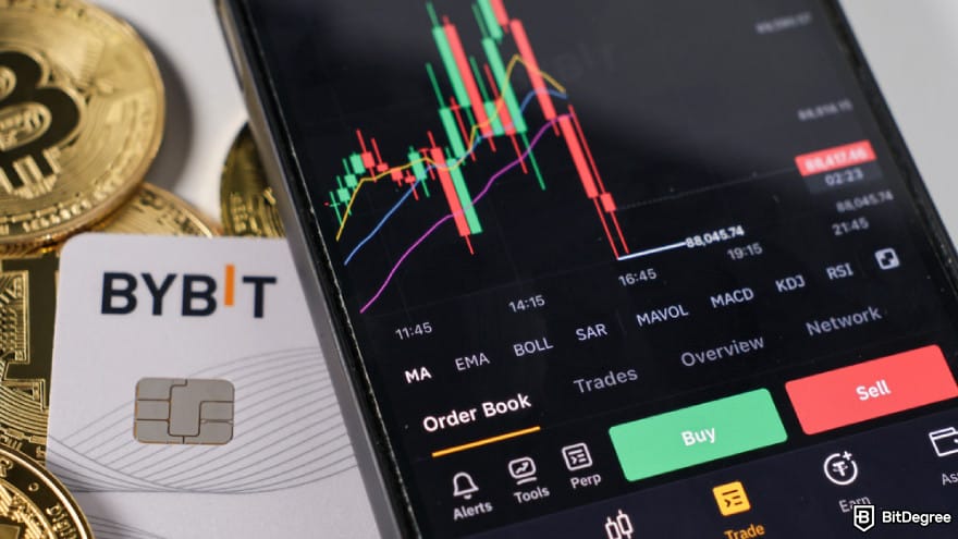 How to buy EarthMeta: Bybit app on smartphone screen with Bitcoin coins.