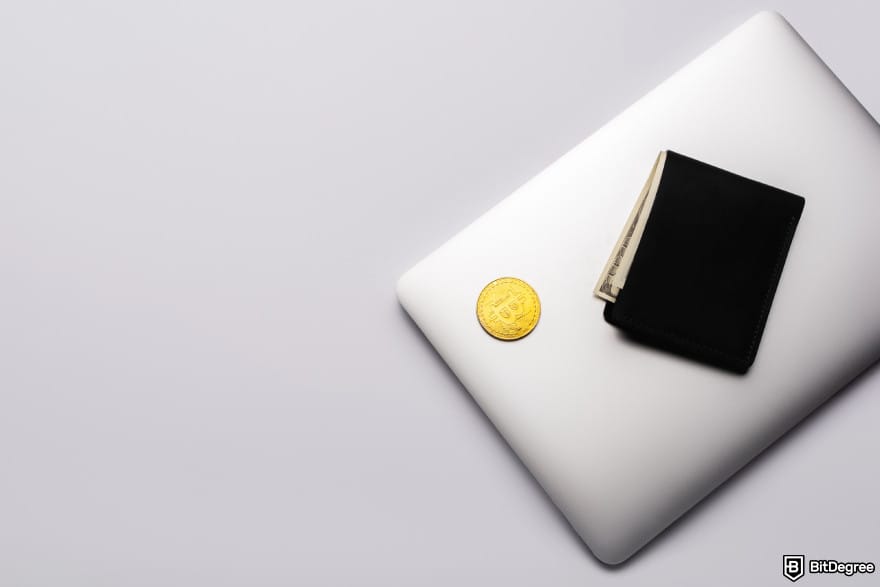 How to buy Lightchain AI: a coin and a wallet on top of a laptop.