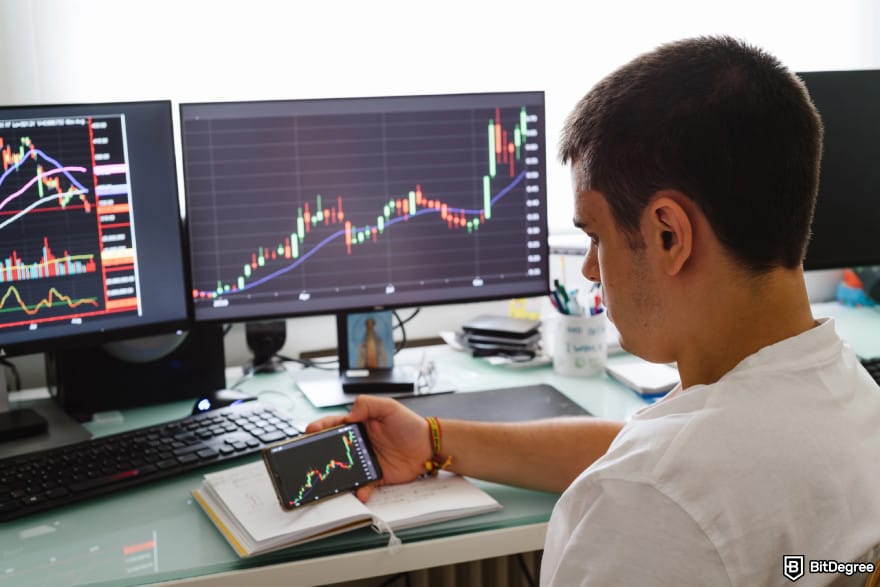 How to buy RXS coin: casual trader holding a phone checking the market condition.