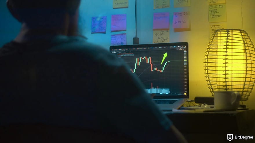 How to buy XYZVerse: a man opening a trading tab that shows an increasing performance.