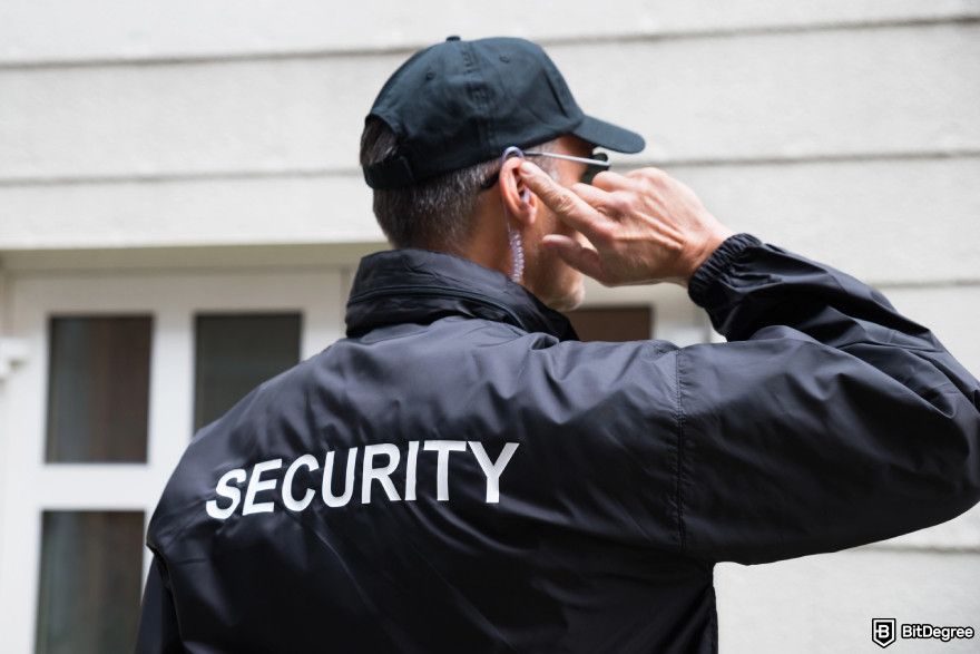 How to choose a crypto exchange: a security personnel listening to an earpiece.