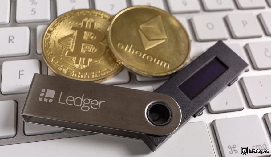 How to claim Jupiter airdrop: a Ledger wallet next to a Bitcoin and an Ethereum coin.
