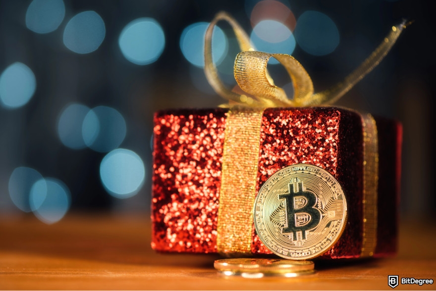 How to get crypto airdrops: a present with a Bitcoin on it.