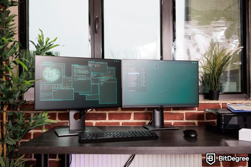 How to make a video game: Two monitors displaying codes and programming software.