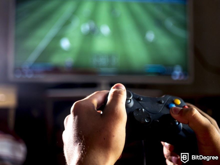 How to make a video game: A person playing a football video game.