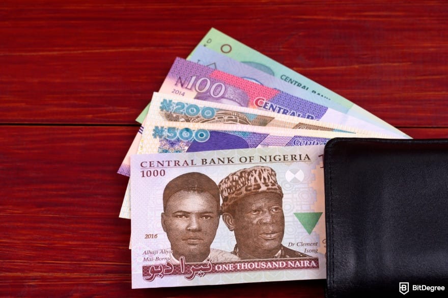 How to make money online in Nigeria: Nigerian naira banknotes tucked into a black wallet.