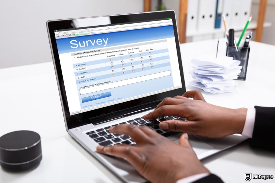How to make money online in Nigeria: a businessman filling a survey on his laptop.
